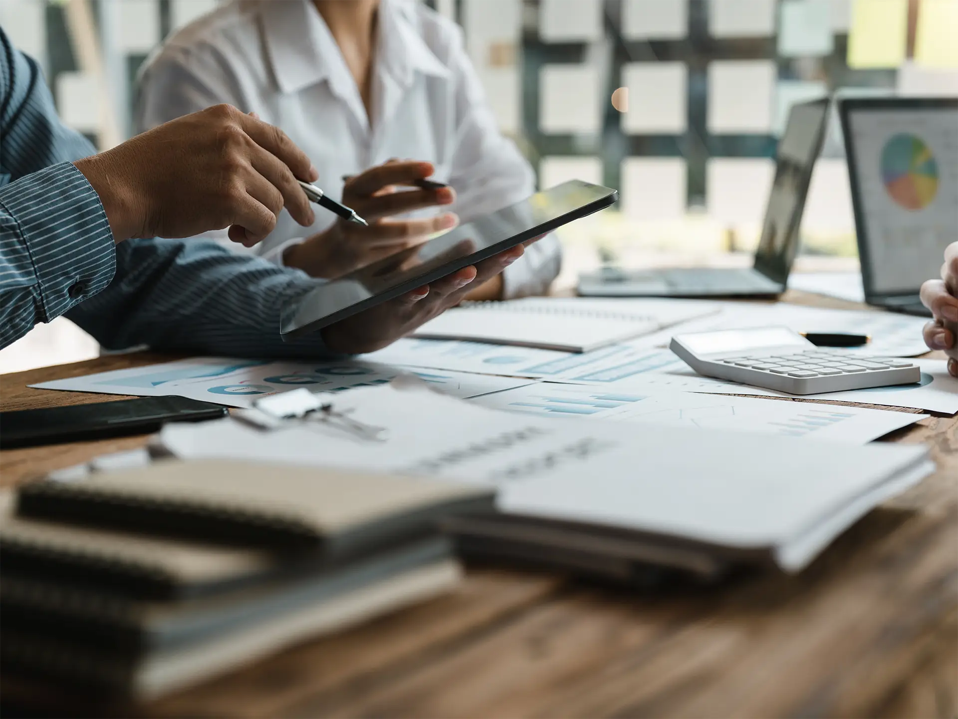 people in a meeting examining documents close up image