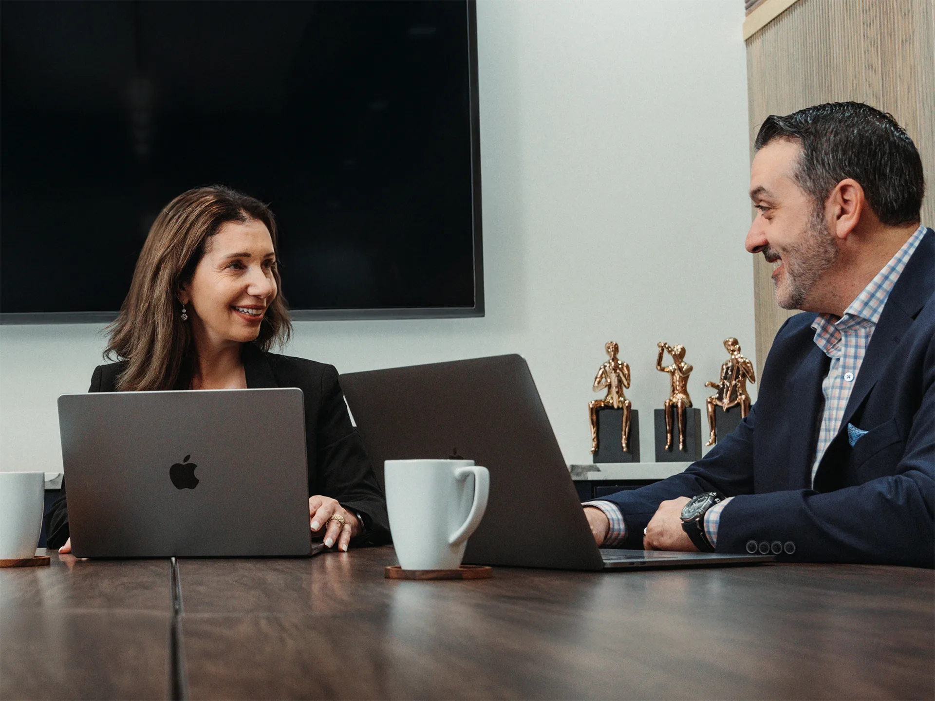 two Aurum leadership team members in meeting room image